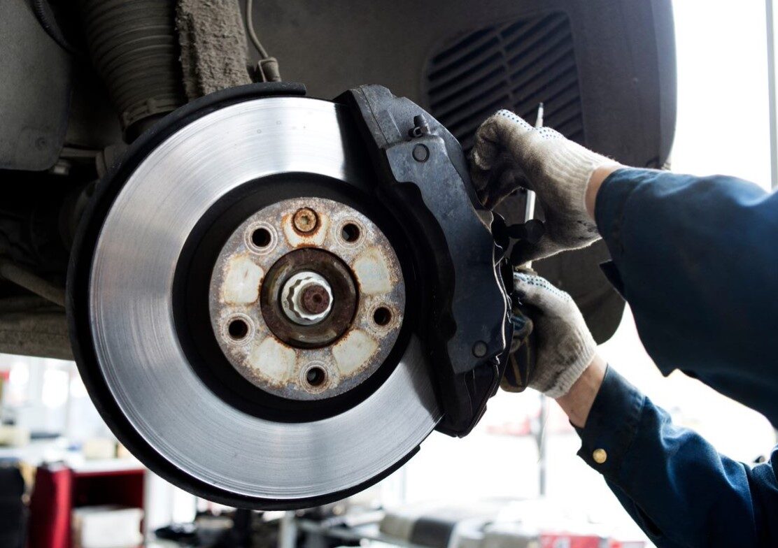 car mechanic repairing a car's brake