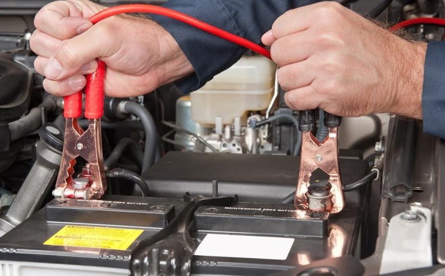 mechanic replacing a car's battery