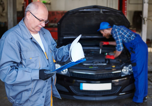 ACT Roadworthy Inspection mechanic checking car with checklist