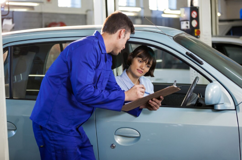 Roadworthy Certificate inspection with mechanic and driver at car service